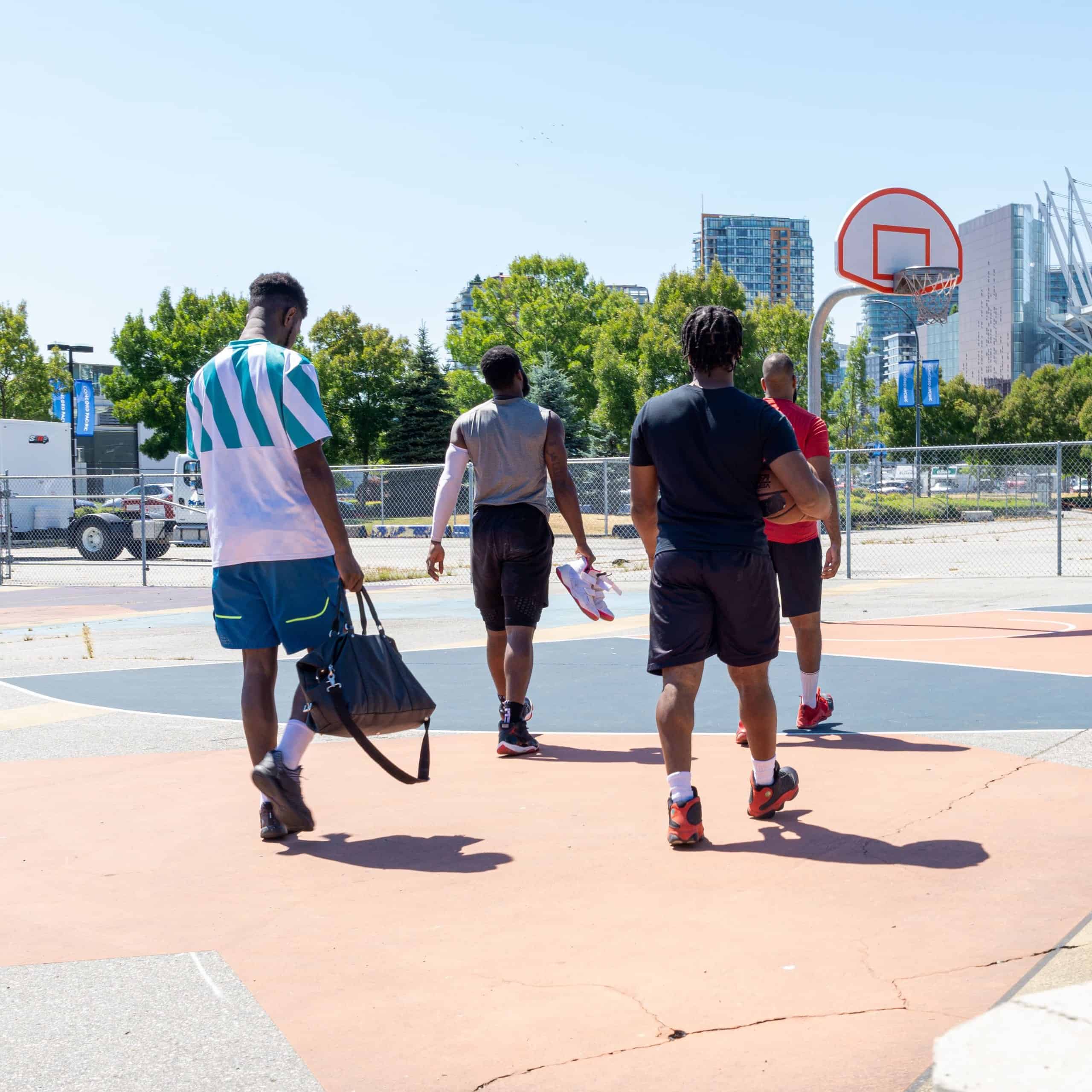 Friends walking onto an outdoor basketball court